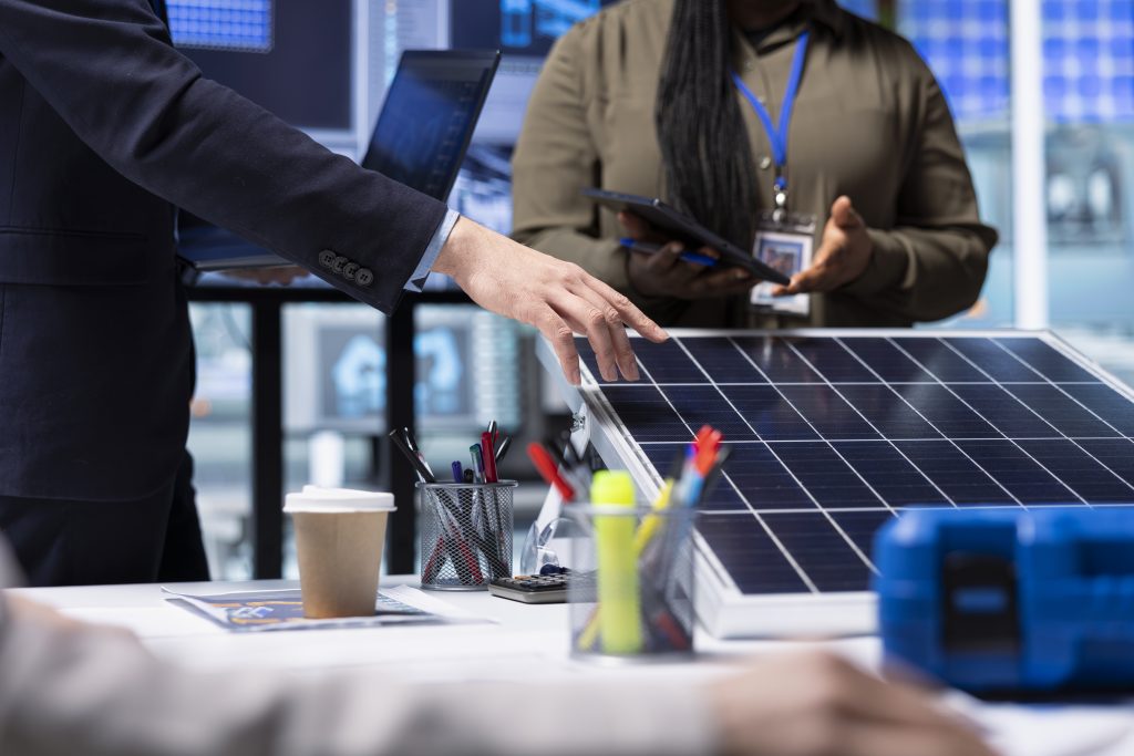 Engineers reviewing solar panel installation plans